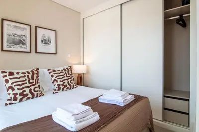 a bedroom with a bed with towels on it at Stylish & Sunny 2BR near Heroísmo by LovelyStay in Porto