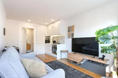 a living room with a couch and a large television at ON Apartments - Constituição 1386 in Porto