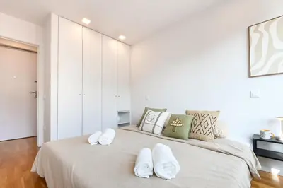 a bedroom with a large bed with two towels on it at ON Apartments - Constituição 1386 in Porto