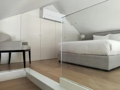 a bedroom with a bed and a chair and a desk at Timeless Elegance Boutique for two in Porto