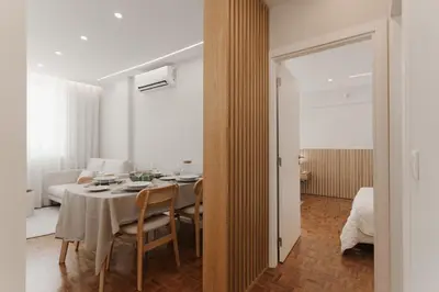 a dining room with a table and a bedroom at O Navegador in Porto