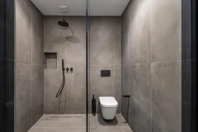 a bathroom with a shower stall and a toilet at Aspasios Baixa Apartments in Porto