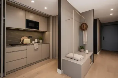 a kitchen with white cabinets and a counter top at Aspasios Baixa Apartments in Porto