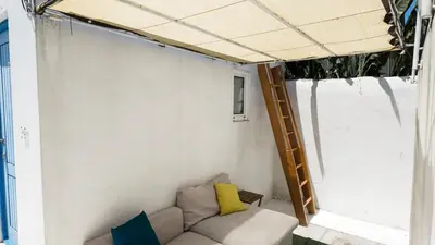 a living room with a couch and a ladder at Bonfim Residence in Porto