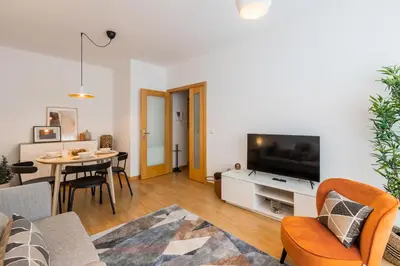 a living room with a couch and a tv and a table at Porto Stay no Marques with AC and parking place in Porto
