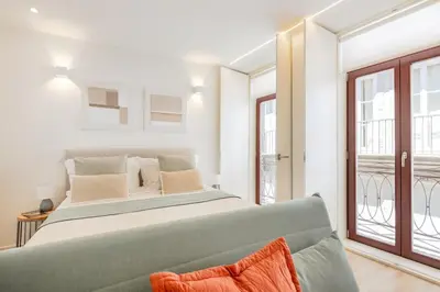 a bedroom with a large bed and a couch at Studio Central | 111 Collection in Porto