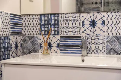 a bathroom with a sink and tiles on the wall at Central Porto Hideaway with Sunny Terrace by Lisbeyond in Porto