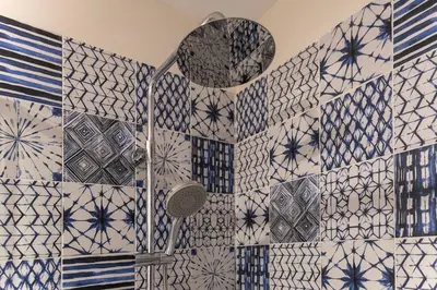 a bathroom with blue and white tiles on the wall at Central Porto Hideaway with Sunny Terrace by Lisbeyond in Porto