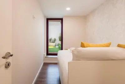 a bedroom with a white bed and a window at Central Porto Hideaway with Sunny Terrace by Lisbeyond in Porto