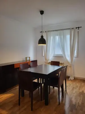 a dining room table with chairs and a window at Casa da travessa familial e com terraço in Porto