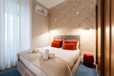 a bedroom with a large bed with orange pillows at GuestReady - Tempting getaway in Porto in Porto