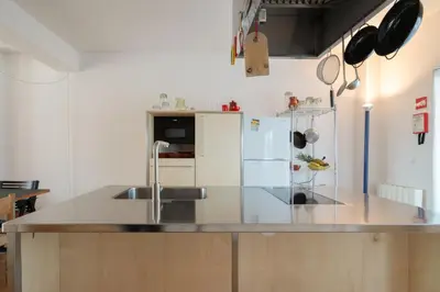 a kitchen with a sink and a refrigerator at Stylish Flat w/ Terrace & Views by HostWise in Porto