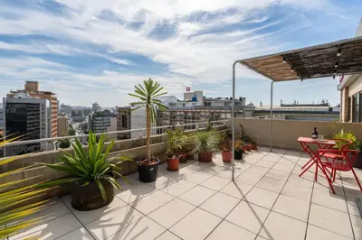a balcony with a table and potted plants on it at Stylish Flat w/ Terrace & Views by HostWise in Porto