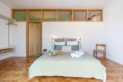 a bedroom with a bed with a tray of towels at Stylish Flat w/ Terrace & Views by HostWise in Porto