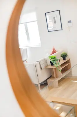 a living room with an orange couch and a desk at Clérigos Loft | 111 Collection in Porto