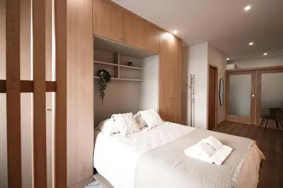 a bedroom with a bed with two towels on it at Bleu Alma Apartment in Porto