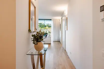 a hallway with a glass table and a vase with a plant at Quinta de Sao Marcos Suite Deluxe in Vila Nova de Gaia
