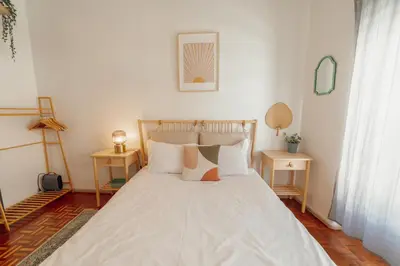 a bedroom with a large white bed with pillows at Santa Catarina Flat 2BD with Balcony by Vacationy in Porto