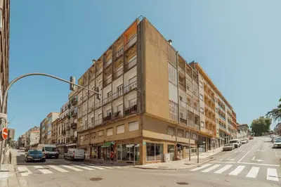 a building on the corner of a street at Santa Catarina Flat 2BD with Balcony by Vacationy in Porto