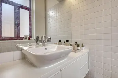 a white bathroom with a sink and a mirror at OPORTO GUEST Downtown Escape in Porto