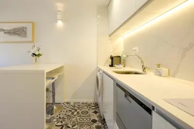 a bathroom with a white toilet in a room at Cozy Downtown House in Porto