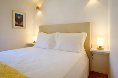 a small kitchen with a table and a couch at Cozy Downtown House in Porto