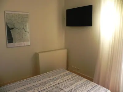 a bedroom with a bed and a television on the wall at Porto Breeze in Porto