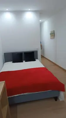 a red and white bed in a white room at Open-Air Terrace Studio in Historic Heart of Porto in Porto