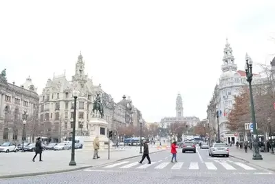 a group of people crossing a street at a crosswalk at Open-Air Terrace Studio in Historic Heart of Porto in Porto