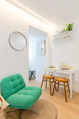 a living room with a green couch and a window at Studio Dash | 111 Collection in Porto
