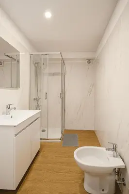 a bathroom with a toilet and a sink and a shower at Happy House - Império in Porto