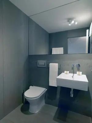 a bathroom with a white toilet and a sink at FLH Porto Modern Flat in Porto