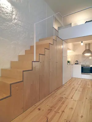 a staircase in a kitchen with wooden flooring at FLH Porto Modern Flat in Porto