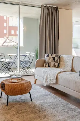 a living room with a couch and a table at Premium Apartments with Garage by HostWise in Porto