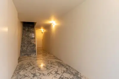 a hallway with a stone wall and lights at Premium Apartments with Garage by HostWise in Porto