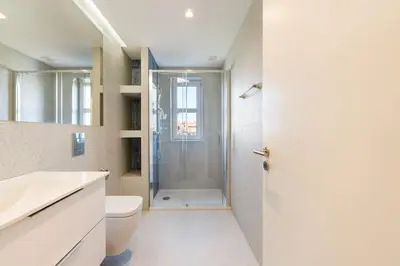a bathroom with a shower and a toilet and a sink at GuestReady - Urban retreat in Porto in Porto