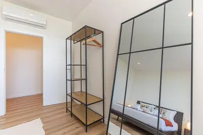 a glass bookcase in a room with a bed at GuestReady - Urban retreat in Porto in Porto