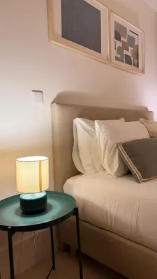 a bedroom with a bed and a table with a lamp at Guindais River View I in Porto