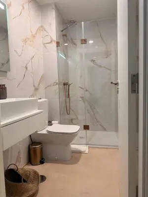 a white bathroom with a toilet and a shower at Guindais River View I in Porto