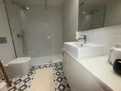 a white bathroom with a sink and a toilet at Jardins de Cedofeita Apartment by Oporto Soul in Porto