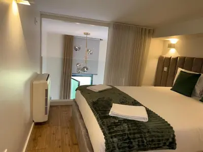 a hotel room with a bed and a window at Jardins de Cedofeita Apartment by Oporto Soul in Porto