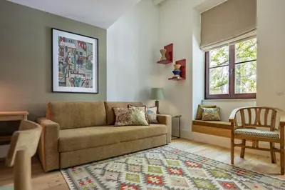 a living room with a couch and a chair at Luxurious Flat in Award-Winning Building in Porto