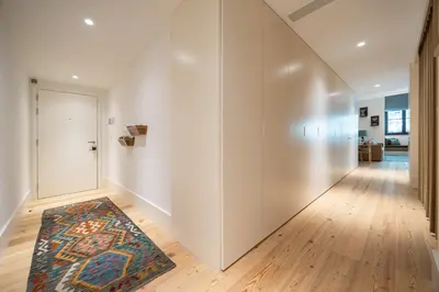 an empty hallway with a door and a rug at Luxurious Flat in Award-Winning Building in Porto