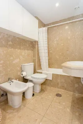 a bathroom with a toilet and a sink at Liiiving in Gaia - Douro Balcony View in Vila Nova de Gaia