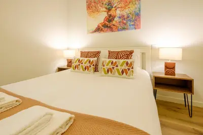 a bedroom with a large white bed with two pillows at Magnolia 1 Luxury with AC Metro Downtown Porto in Porto