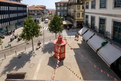 a red fire hydrant on a city street at Magnolia 1 Luxury with AC Metro Downtown Porto in Porto