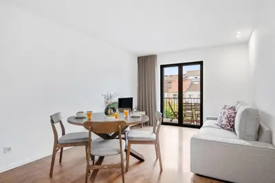 a living room with a couch and a table at Porto Style & Comfort | Balcony + Parking in Porto
