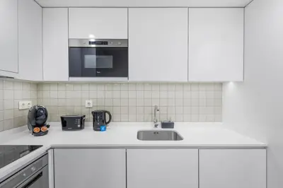 an empty dishwasher with its door open with at Porto Style & Comfort | Balcony + Parking in Porto
