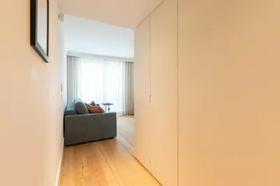 a living room with a couch and a window at Chic 1-BR Flat in Award-Winning Building in Porto