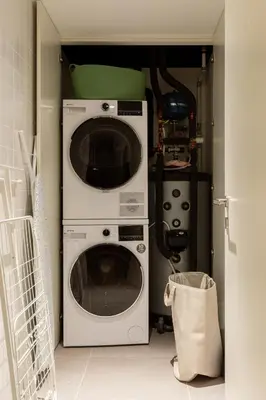 a kitchen with a washer and dryer in a room at Breathtaking Loft in Award-Winning Building in Porto
